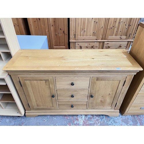 1021 - A modern solid oak sideboard with three central drawers and two outer cupboard doors - approx. 85cm ... 