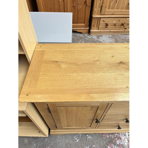 1021 - A modern solid oak sideboard with three central drawers and two outer cupboard doors - approx. 85cm ... 