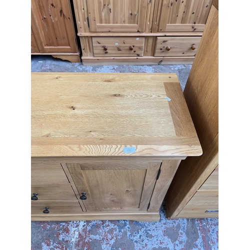 1021 - A modern solid oak sideboard with three central drawers and two outer cupboard doors - approx. 85cm ... 