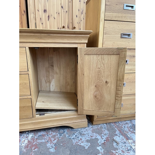 1021 - A modern solid oak sideboard with three central drawers and two outer cupboard doors - approx. 85cm ... 