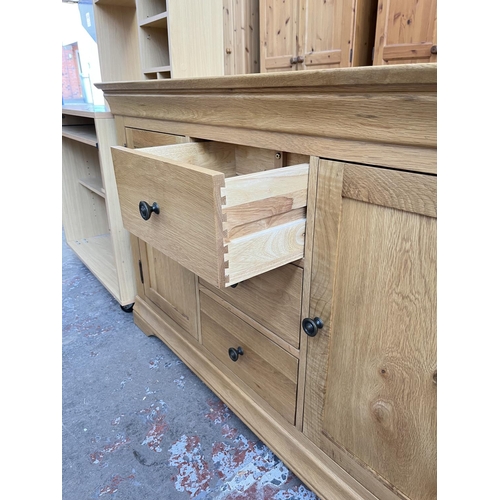 1021 - A modern solid oak sideboard with three central drawers and two outer cupboard doors - approx. 85cm ... 