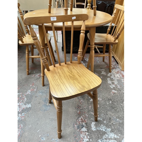 1029 - A modern oak and beech circular dining table and four matching chairs - approx. 74cm high x 90cm dia... 