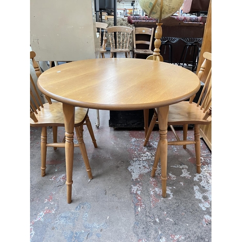 1029 - A modern oak and beech circular dining table and four matching chairs - approx. 74cm high x 90cm dia... 