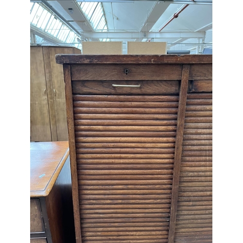 1031 - An early 20th century oak double tambour door cabinet - approx. 152cm high x 87cm wide x 37cm deep