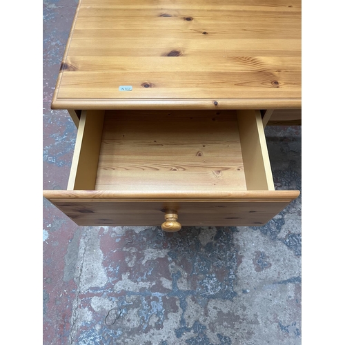 1035 - A modern pine dressing table with three drawers