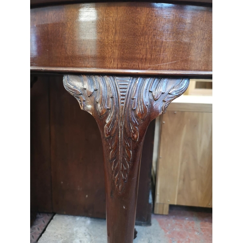 1038 - A Georgian style mahogany fold over card table with ball and claw supports - approx. 75cm high x 90c... 