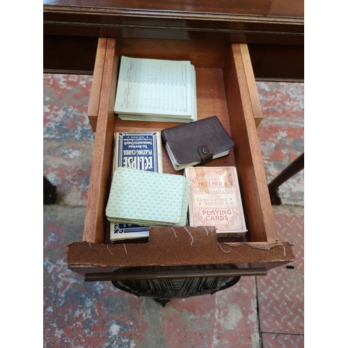 1038 - A Georgian style mahogany fold over card table with ball and claw supports - approx. 75cm high x 90c... 