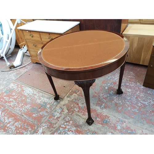 1038 - A Georgian style mahogany fold over card table with ball and claw supports - approx. 75cm high x 90c... 