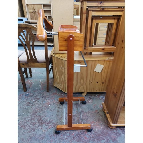 1047 - A modern cherry wood valet stand on castors - approx. 104cm high