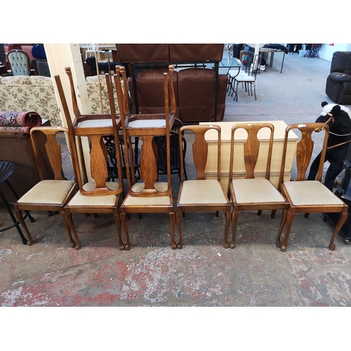 1049 - A set of eight Queen Anne style oak dining chairs