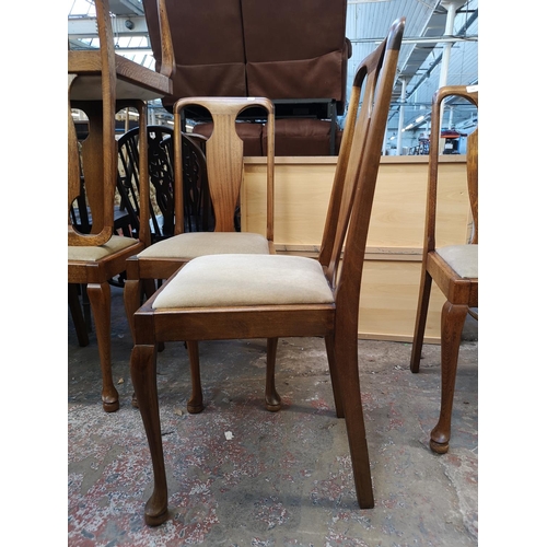 1049 - A set of eight Queen Anne style oak dining chairs