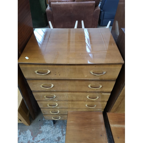 1052 - A mid 20th century walnut effect four piece bedroom suite comprising dressing table, double wardrobe... 