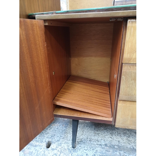 1052 - A mid 20th century walnut effect four piece bedroom suite comprising dressing table, double wardrobe... 