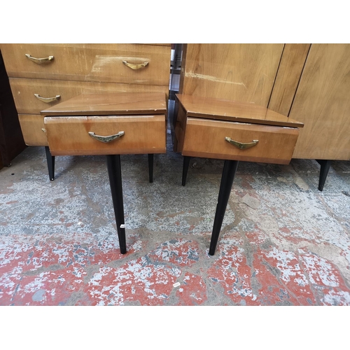 1052 - A mid 20th century walnut effect four piece bedroom suite comprising dressing table, double wardrobe... 