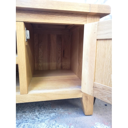 1053 - A modern solid oak TV stand - approx. 51cm high x 120cm wide x 44cm deep