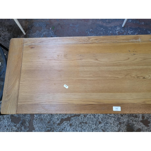 1053 - A modern solid oak TV stand - approx. 51cm high x 120cm wide x 44cm deep