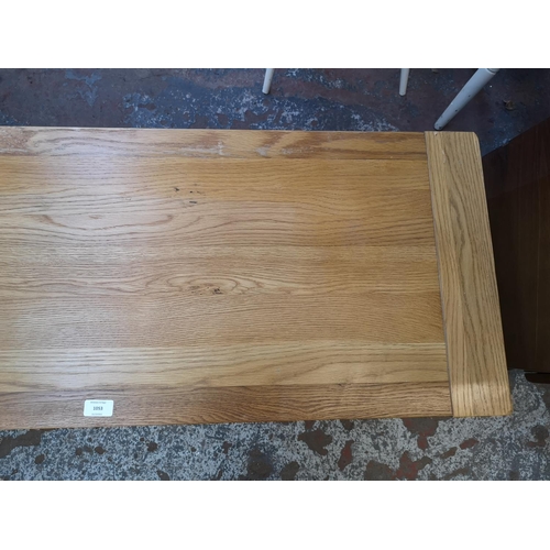 1053 - A modern solid oak TV stand - approx. 51cm high x 120cm wide x 44cm deep