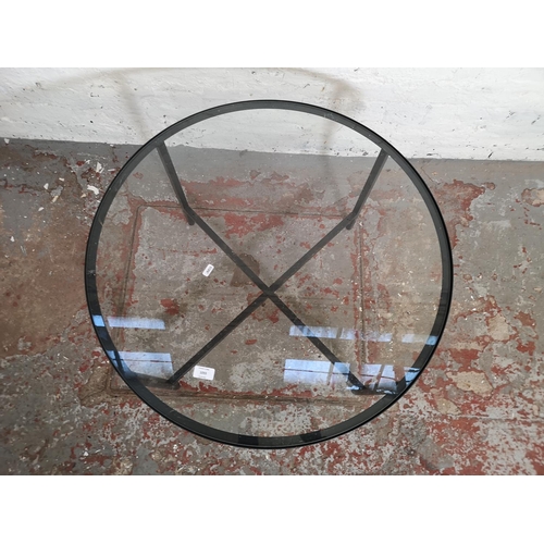 1055 - A modern black metal and glass circular coffee table - approx. 45cm high x 75cm diameter