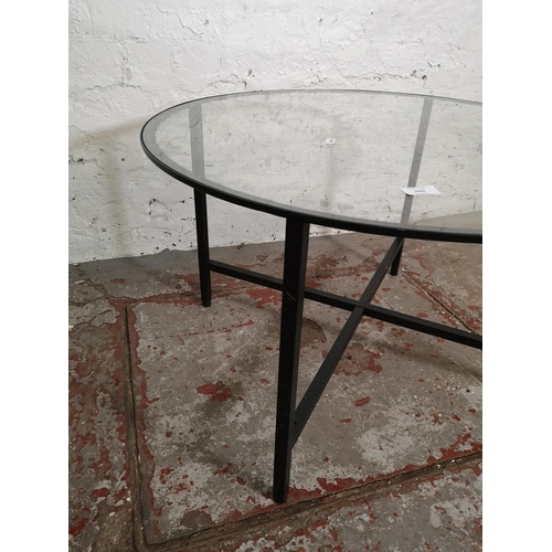 1055 - A modern black metal and glass circular coffee table - approx. 45cm high x 75cm diameter