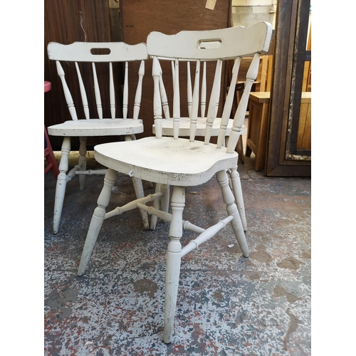 1057 - A set of four grey painted spindle back farmhouse dining chairs