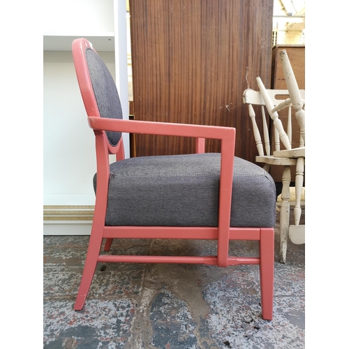 1058 - A modern pink painted and grey fabric upholstered armchair