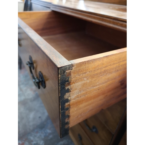 1062 - A mid 20th century walnut sideboard with four central drawers, two outer cupboard doors and cabriole... 