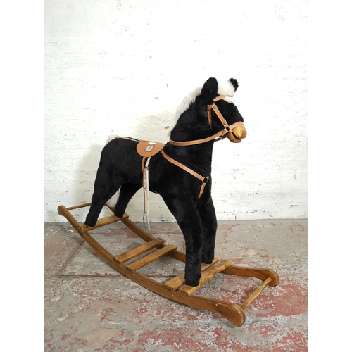 1064B - A Mama's & Papa's rocking horse on wooden stand - approx. 103cm high x 38cm wide x 140cm deep