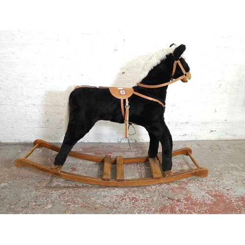 1064B - A Mama's & Papa's rocking horse on wooden stand - approx. 103cm high x 38cm wide x 140cm deep