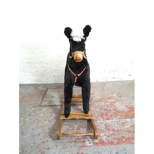 1064B - A Mama's & Papa's rocking horse on wooden stand - approx. 103cm high x 38cm wide x 140cm deep