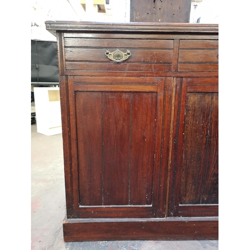 1075 - An Edwardian stained mahogany sideboard with two drawers and two lower cupboard doors - approx. 98cm... 