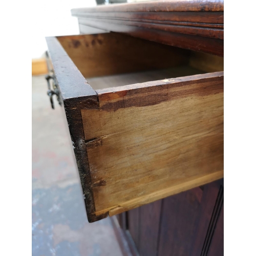 1075 - An Edwardian stained mahogany sideboard with two drawers and two lower cupboard doors - approx. 98cm... 