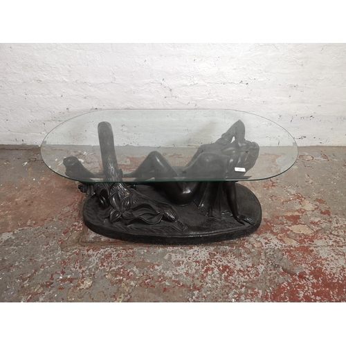 1079 - A bronze effect fibreglass and glass top nude lady coffee table - approx. 39cm high x 60cm wide x 11... 