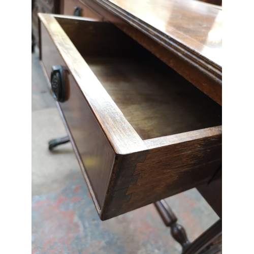 1082 - A Regency style mahogany drop leaf lyre end sofa table with two drawers