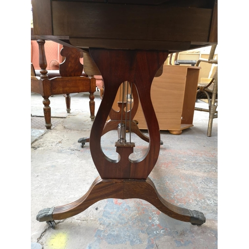 1082 - A Regency style mahogany drop leaf lyre end sofa table with two drawers