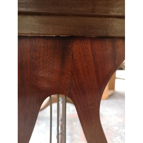 1082 - A Regency style mahogany drop leaf lyre end sofa table with two drawers