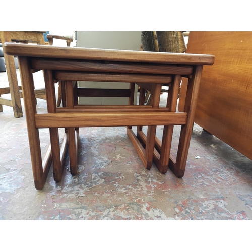 1087 - A mid 20th century teak and tiled top nest of three tables