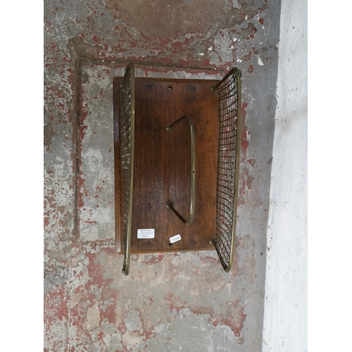 1092A - An early 20th century oak and brass adjustable magazine rack - approx. 78cm high