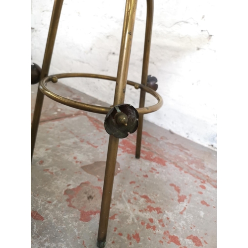 1092A - An early 20th century oak and brass adjustable magazine rack - approx. 78cm high