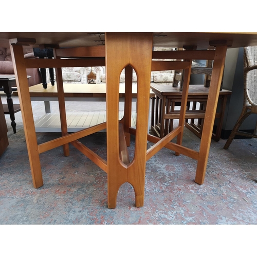 1095 - Three pieces of mid 20th century furniture, one teak drop leaf gate leg dining table, one teak and b... 