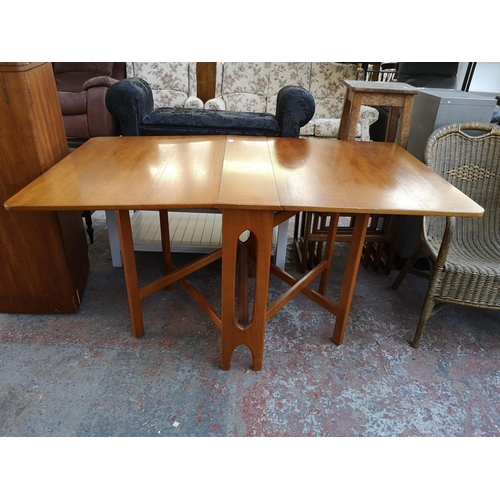 1095 - Three pieces of mid 20th century furniture, one teak drop leaf gate leg dining table, one teak and b... 