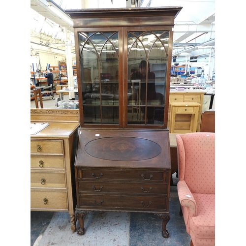 1107 - A Georgian style mahogany bureau bookcase with two upper glazed doors, fall front, three drawers and... 