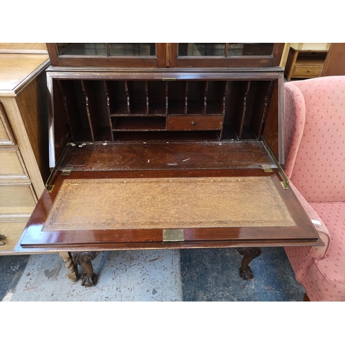 1107 - A Georgian style mahogany bureau bookcase with two upper glazed doors, fall front, three drawers and... 