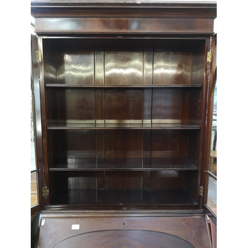 1107 - A Georgian style mahogany bureau bookcase with two upper glazed doors, fall front, three drawers and... 