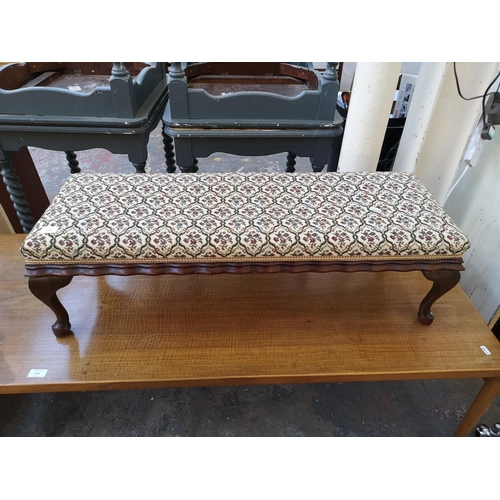 1114 - An early 20th century mahogany and floral upholstered rectangular footstool - approx. 30cm high x 35... 