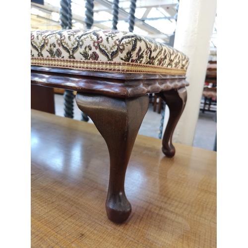 1114 - An early 20th century mahogany and floral upholstered rectangular footstool - approx. 30cm high x 35... 