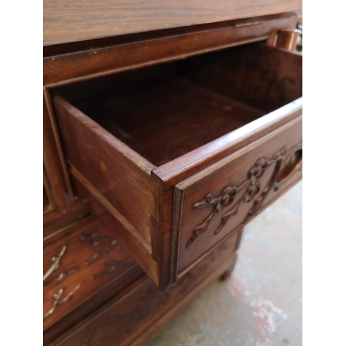 1117 - A Chinese rosewood bureau with two short drawers, two long drawers, fall front and bird and foliate ... 