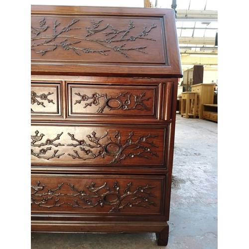 1117 - A Chinese rosewood bureau with two short drawers, two long drawers, fall front and bird and foliate ... 