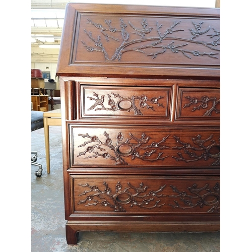 1117 - A Chinese rosewood bureau with two short drawers, two long drawers, fall front and bird and foliate ... 