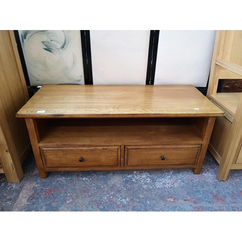 1131 - A modern oak TV stand with two lower drawers - approx. 47cm high x 110cm wide x 48cm deep