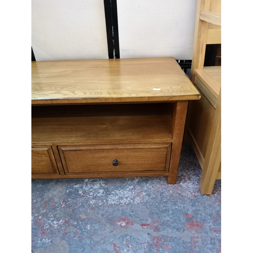 1131 - A modern oak TV stand with two lower drawers - approx. 47cm high x 110cm wide x 48cm deep